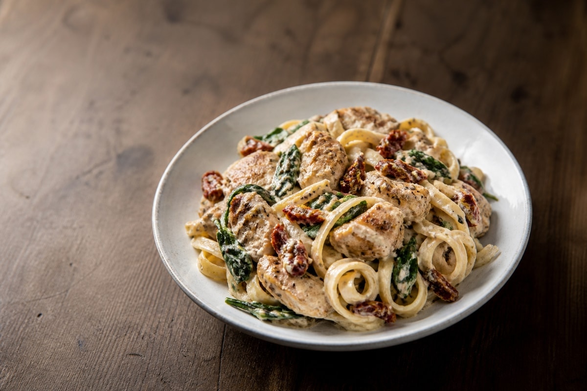 Creamy Tuscan chicken pasta with spinach and sun-dried tomatoes