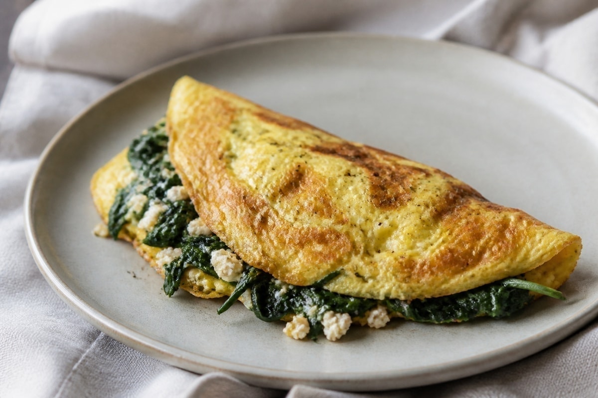 Spinach and feta omelette folded on a plate
