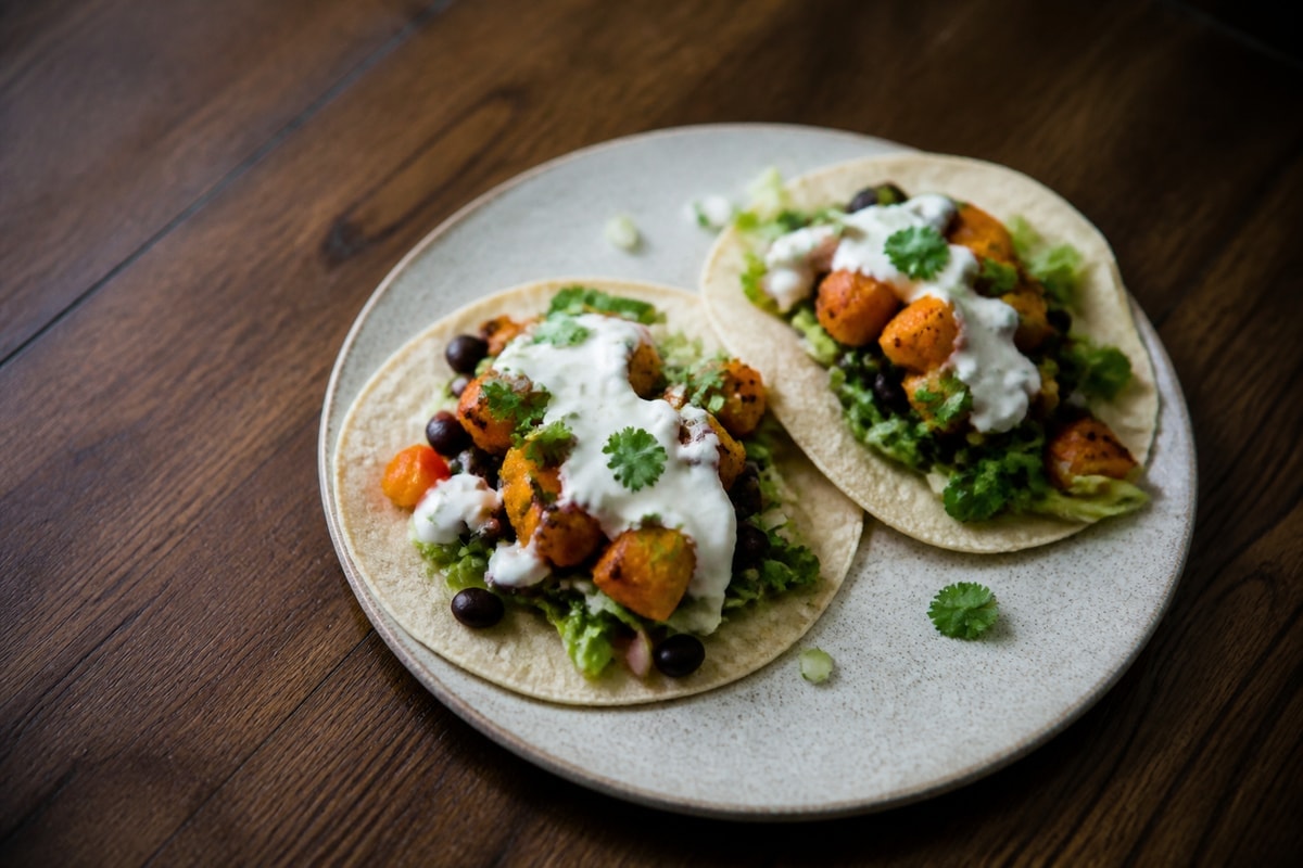 Sweet potato and black bean tacos with yogurt and cheese